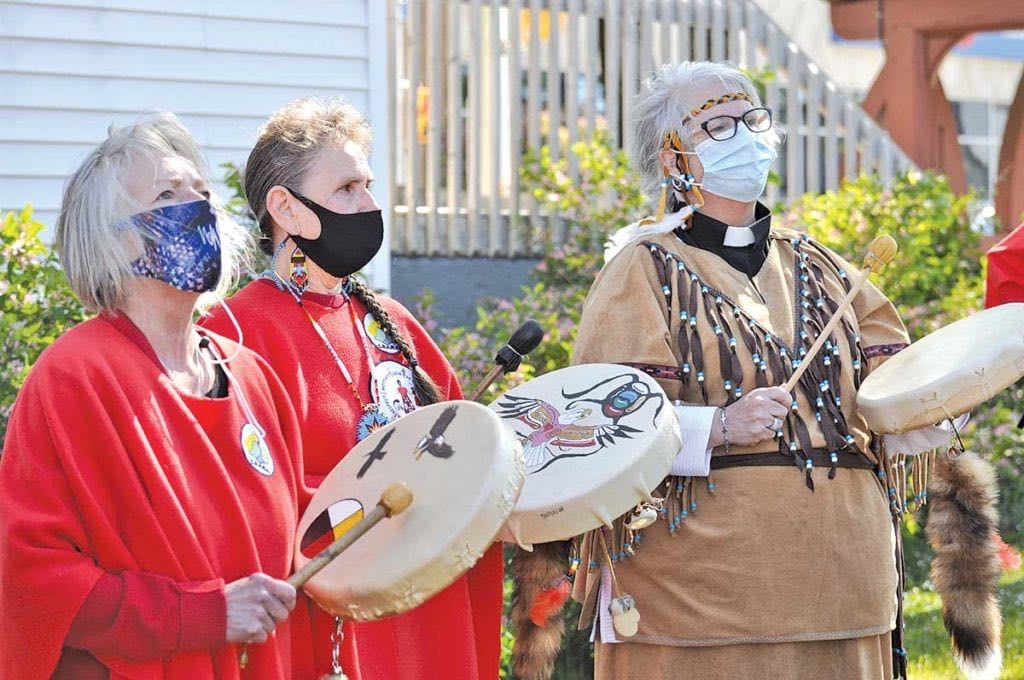 Glenda Buckle (left) and Margie Benoit Wheeler of the Corner Brook Aboriginal Women’s Association and Rev. Deacon Karen Loder of the North Shore Aboriginal Group drummed during the flag raising outside the Anglican Cathedral of St. John the Evangelist in Corner Brook on June 9th.