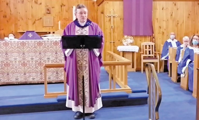 The Rev'd J. Noel at the Church of St. John the Evangelist, Topsail