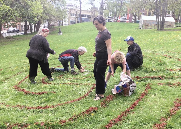 people re-establishing the labyrinth in the cathedral yard in St. John's
