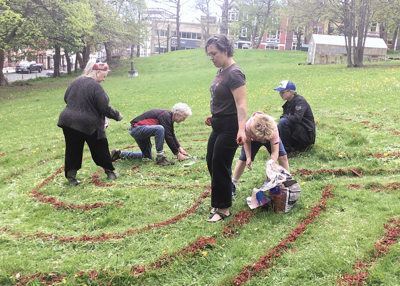 people re-establishing the labyrinth in the cathedral yard in St. John's