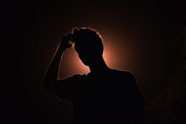 man with hand on his head