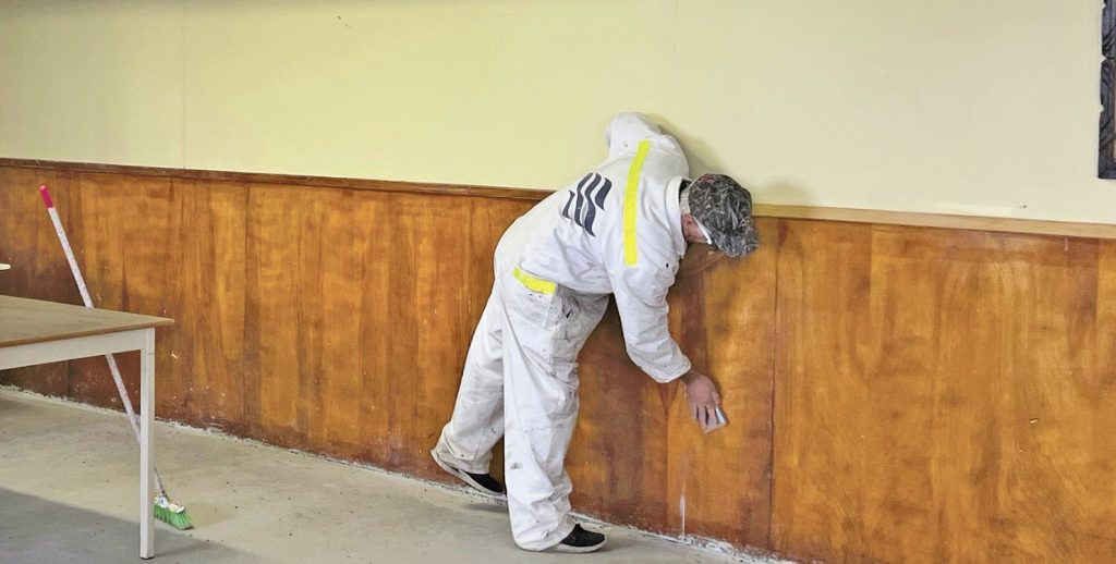 man sanding panelling