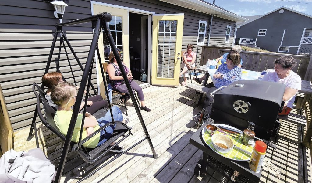 people on the deck enjoying the parish BBQ