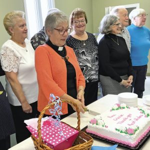 Gloria cutting back with group of parishioners