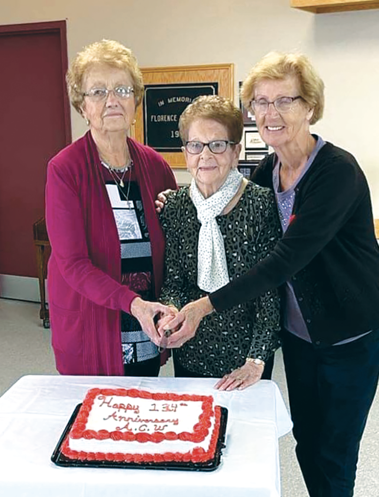 three women cut cake