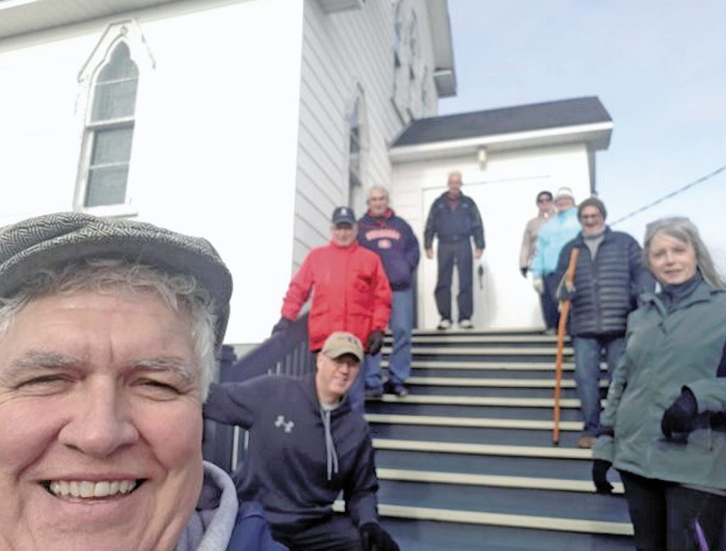 People on the steps of a chuch in Central NL