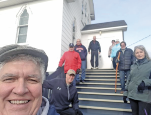 People on the steps of a chuch in Central NL
