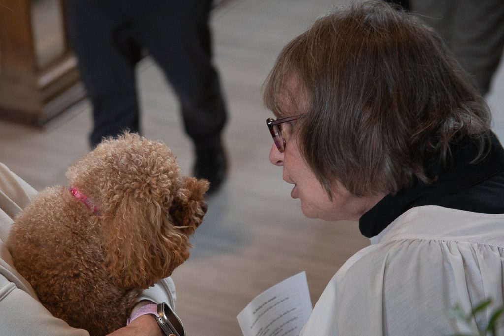 Woman speaks to dog in the Anglican Cathedral of St. John the Baptist, St. John's, Newfoundland.