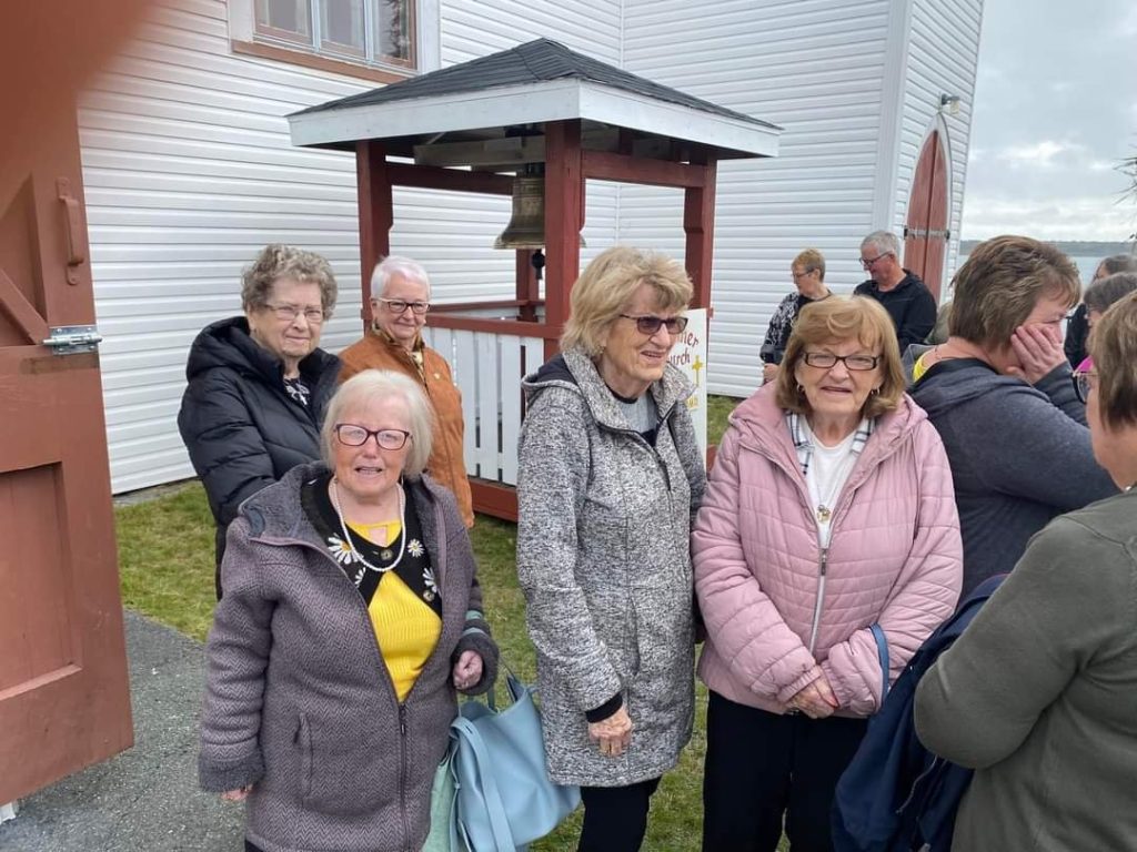 people gathered for rededication of church bell in Spainiard's Bay Newfoudland.