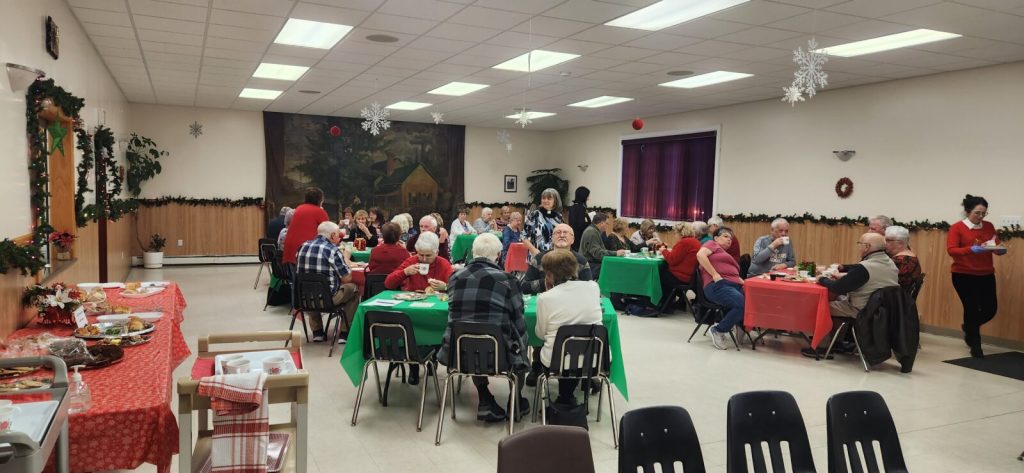senior citizens enjoying a cup of tea and a meal in a church hall, Bay Roberts Newfoundland.