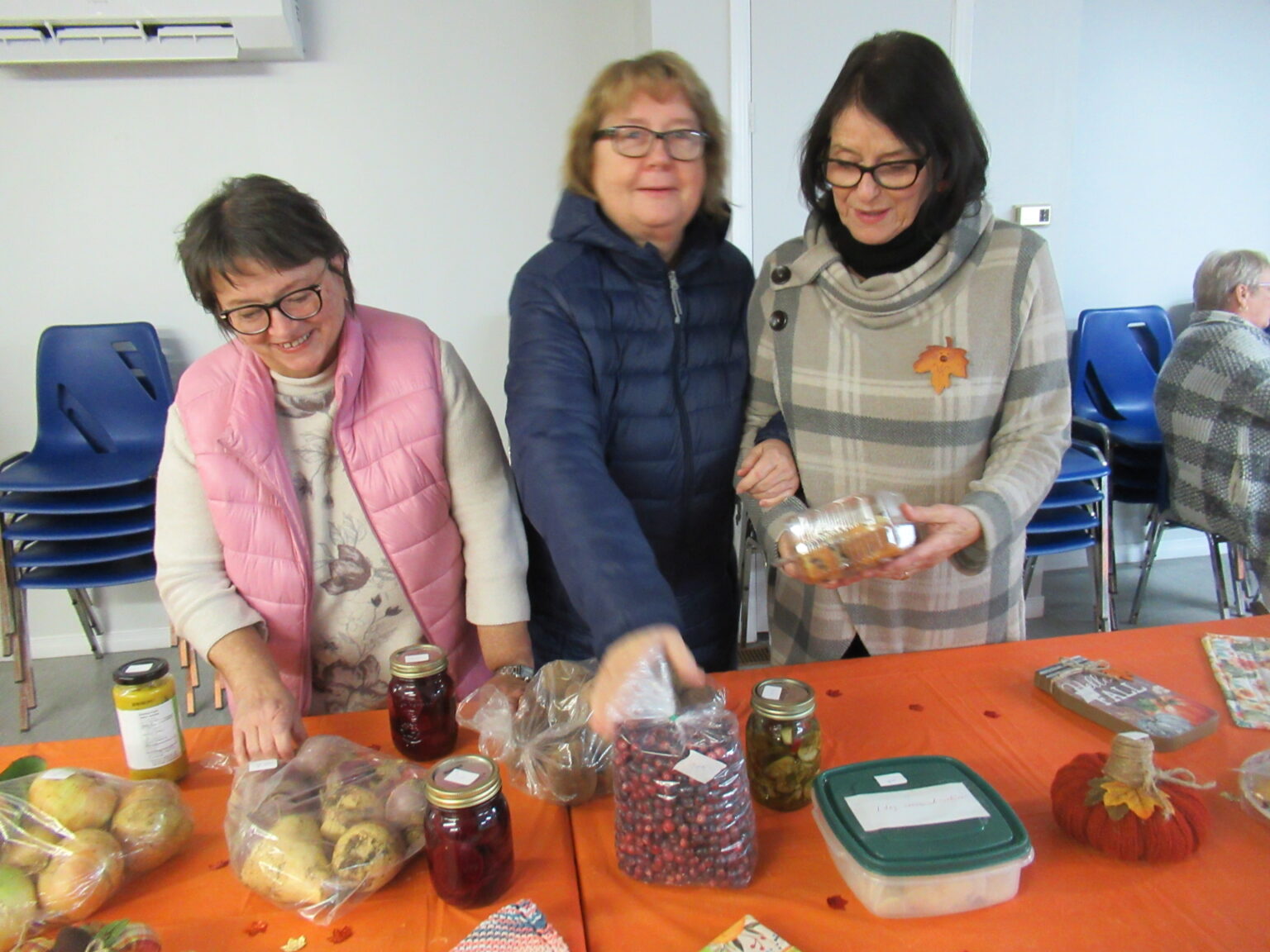 women happy to be working at flea market, Cow Head, Newfoundland.