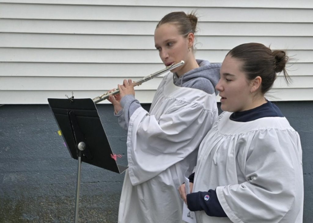 choir members singing and playing the flute for at animal blessing in Corner Brook Newfoudland.