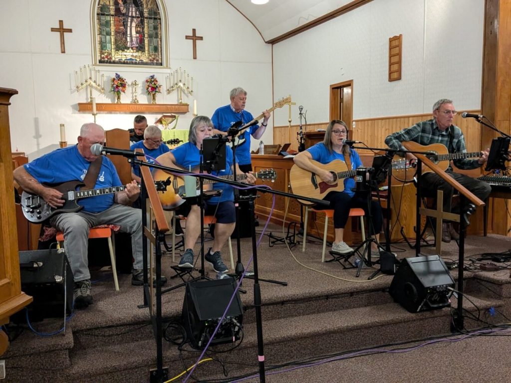 people playing guitars in church