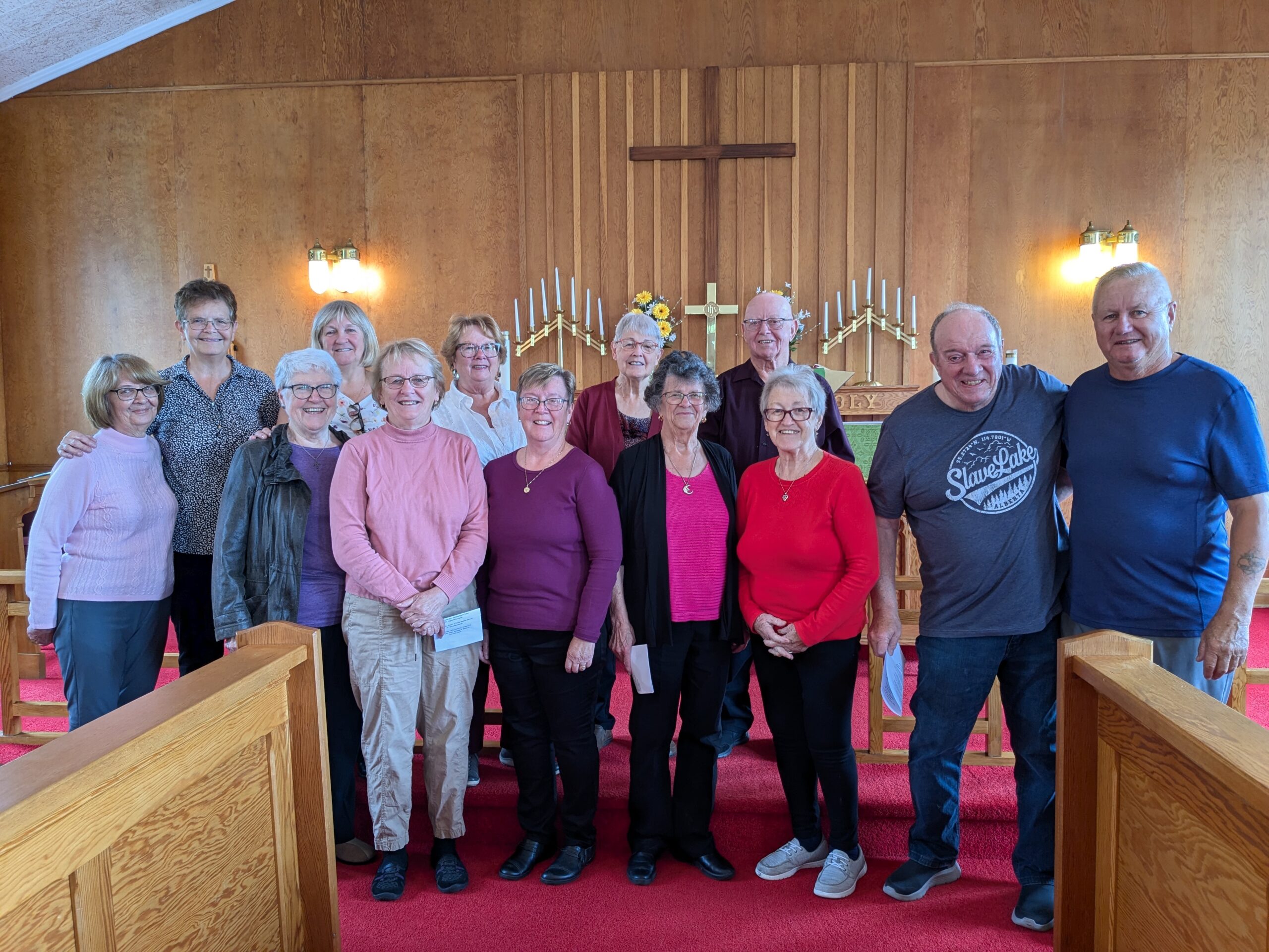 group of people posed together in the front of a church