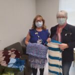 two women with prayer shawls for cancer patients