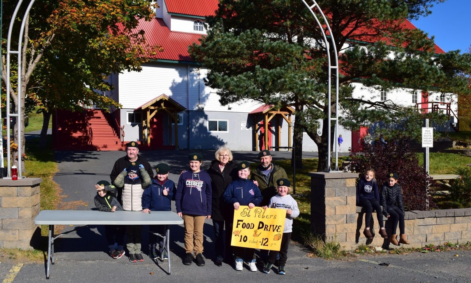 children in uniform working to raise food for a food bank