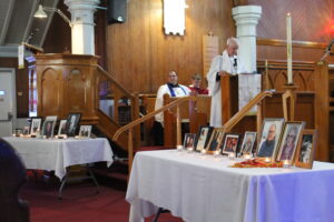 table in church with photos of those who died during the covid lockdowns