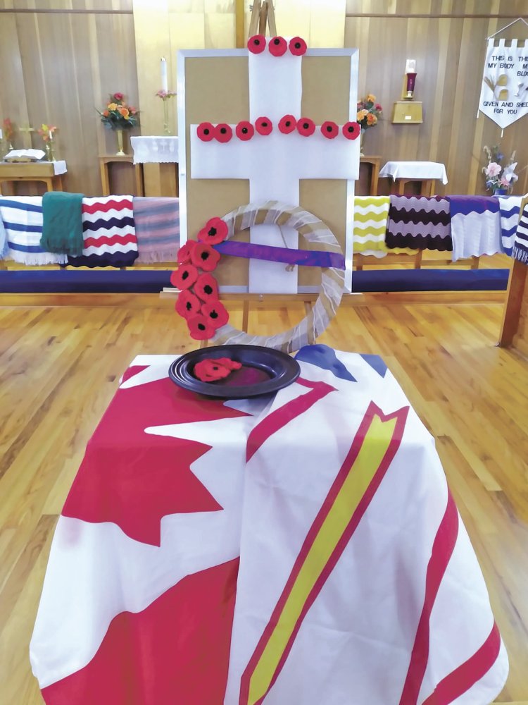 Canadian and Newfoundland flags with a cross for Remembrance Day in a church