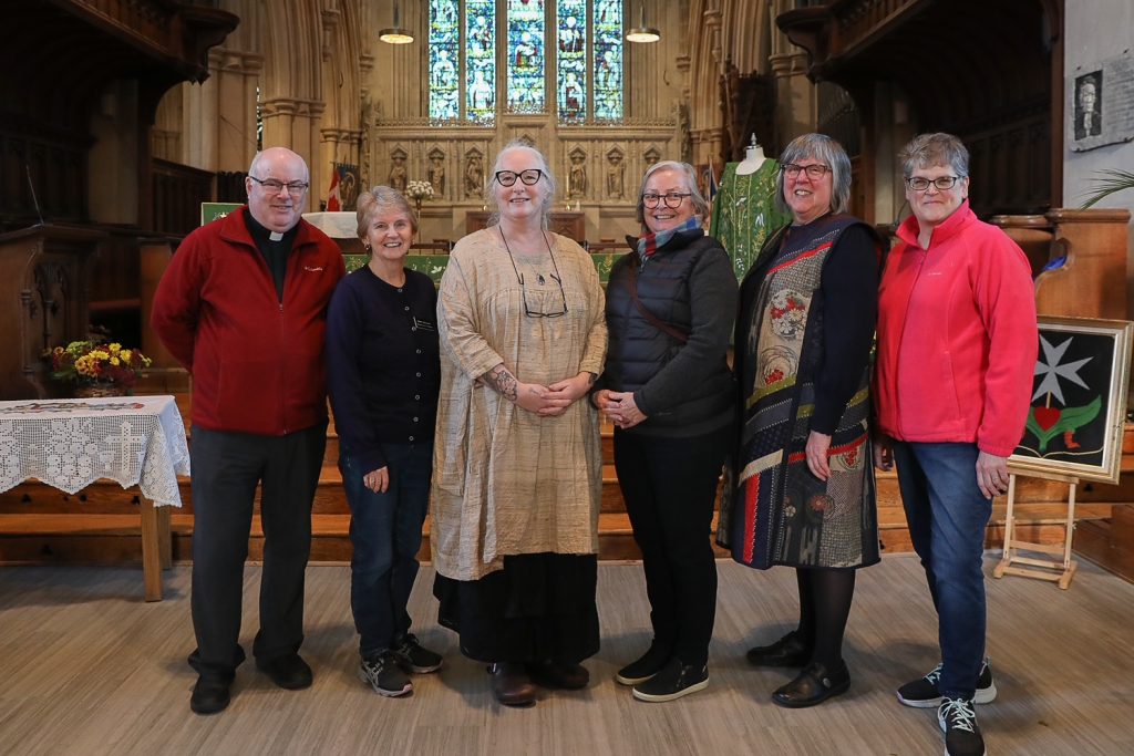 6 people in a stone cathedral