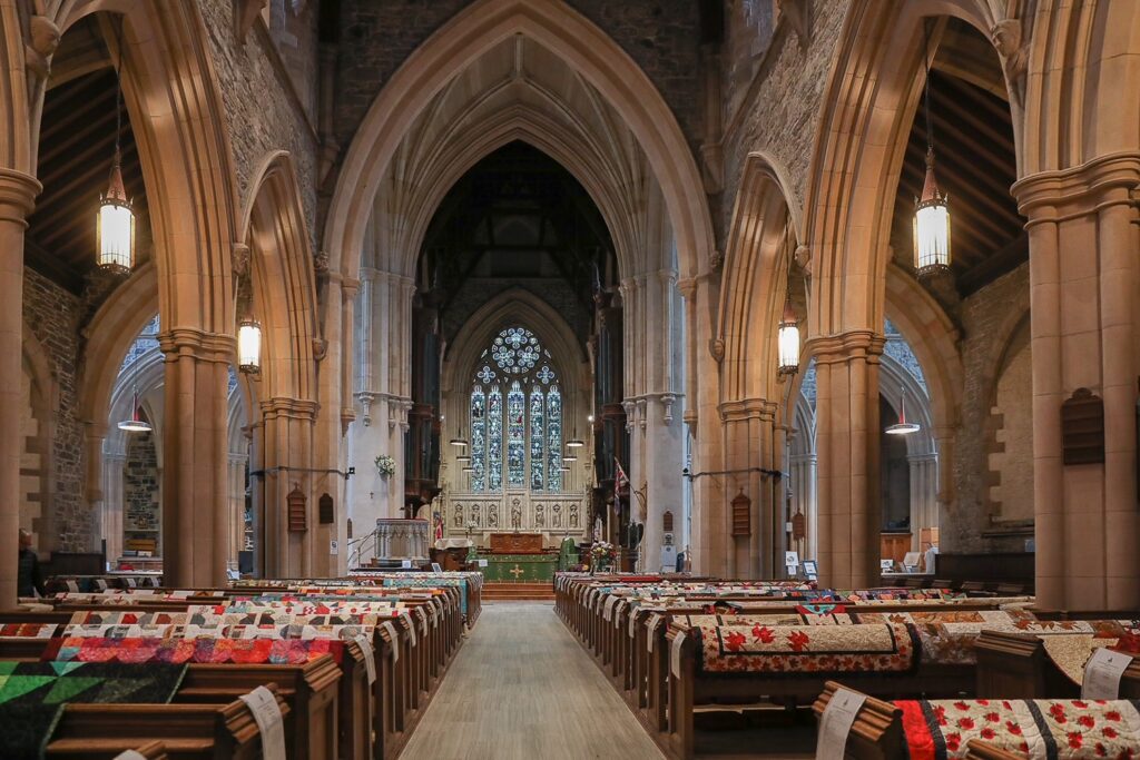 stone cathedral with quilts displayed