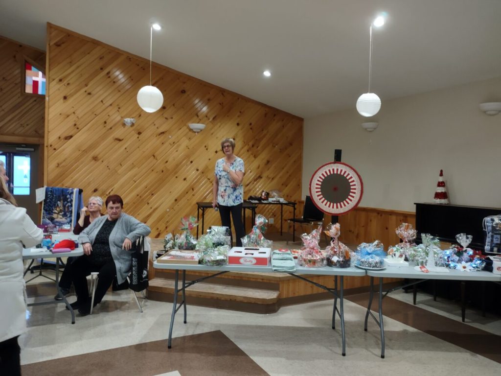 people at a fall sale in a church hall in Bell Island Newfoundland