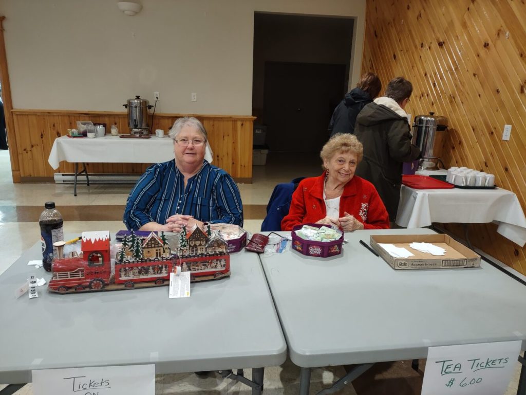 two women at a table at a fall sale in Bell Island Newfoundland