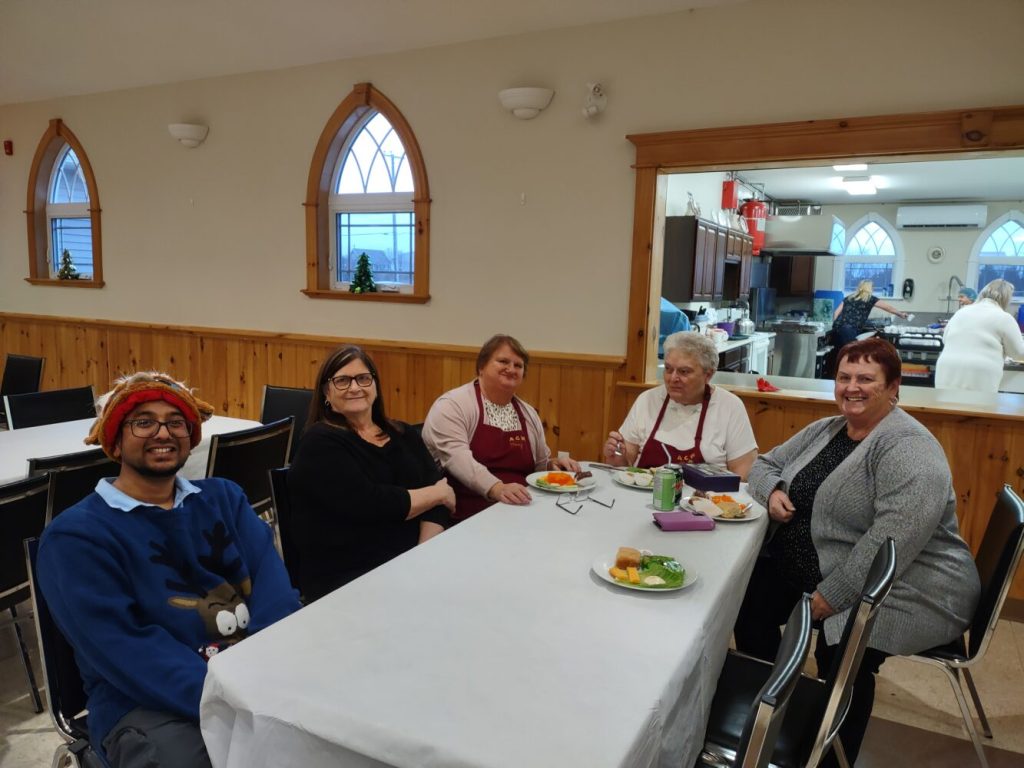 people sitting around a table in a church hall on Bell Island Newfoundland