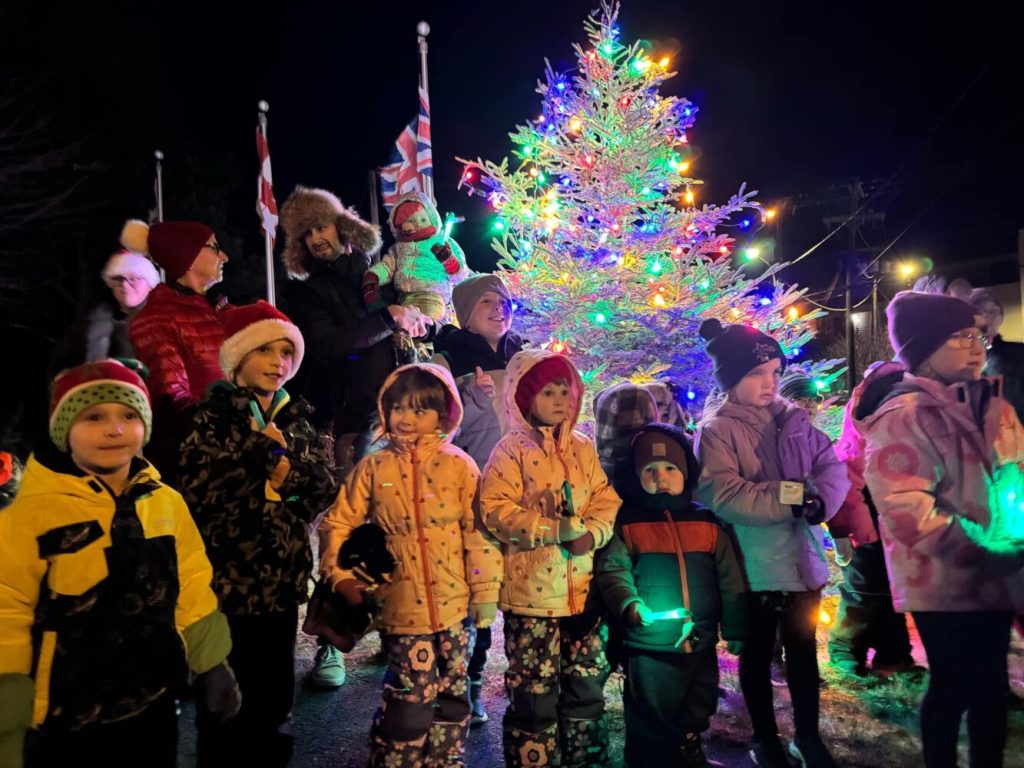 chidren singing at a Christmas tree lighting