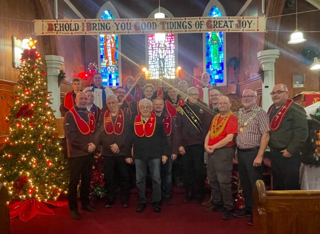 men from the masonic order together at the front of a church at Christmas time
