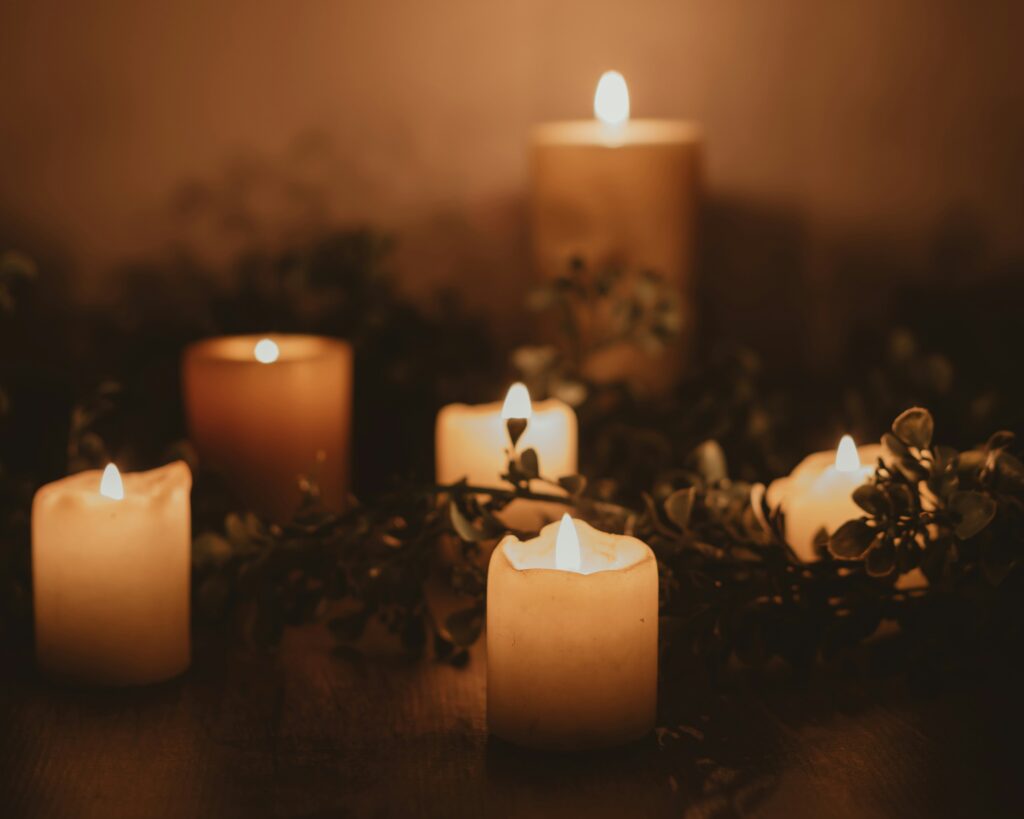 six lit pillar candles giving off a warm glow