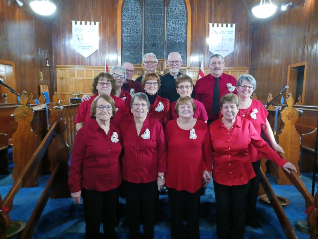 a group of people dressed in red standing at the front of a church