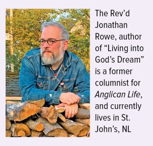 a man leans on stacked firewood, looking off to the left