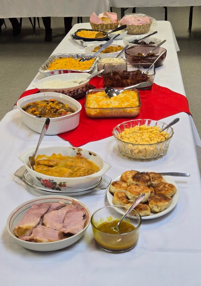 many casseroles and other foods on a table for a potluck supper