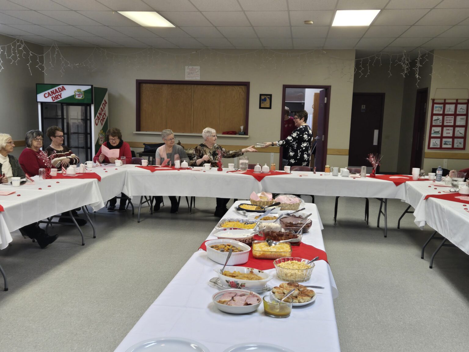 a group of people seated at a table for a Valentine's celebration