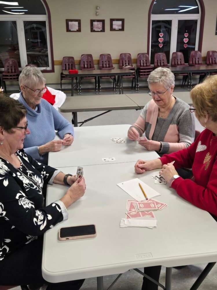 a group of women playing cards at a table