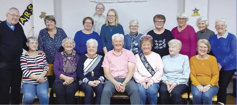 a group of women with two men, one a priest and one a visiting MHA who cam to speak about a recent trip to Uganda