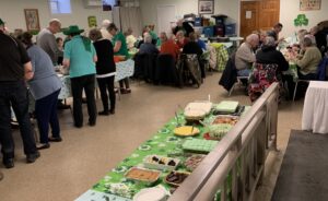 People at a church potluck for St. Patrick's Day, 2025