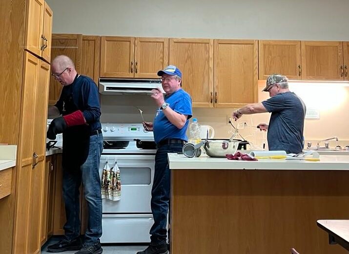 Men preparing pancakes in PAB