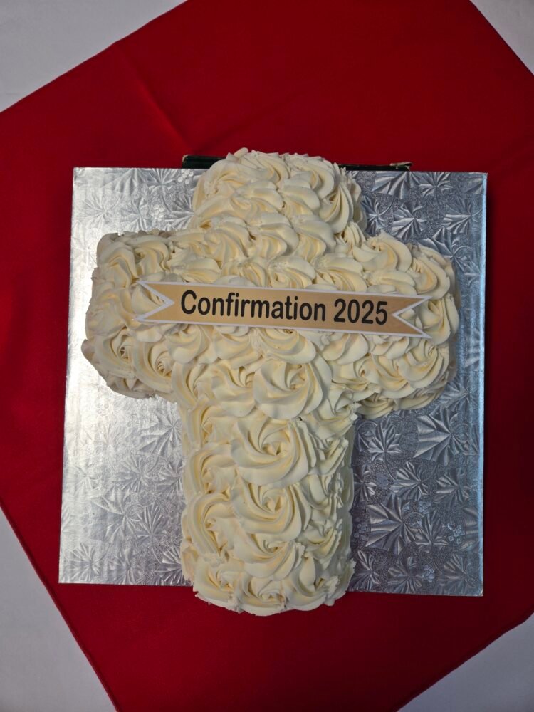 a cake in the shape of a cross with "Confirmation 2025" on it