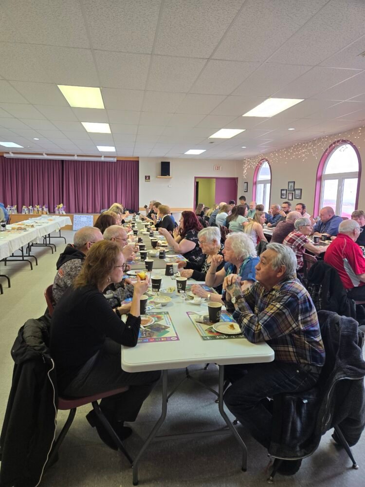 people preparing for a supper in a church hall
