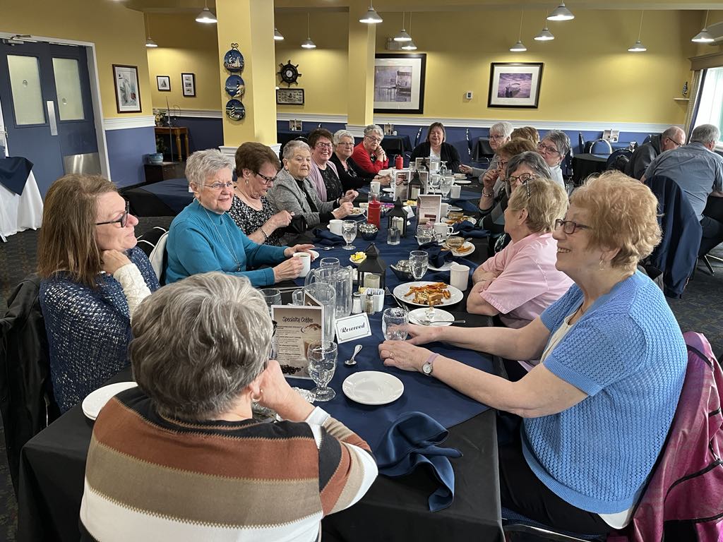 a group of women enjoying a meal in a restaurant
