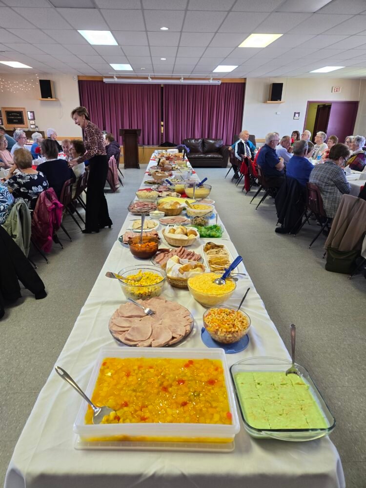 a table full of food for a potluck supper