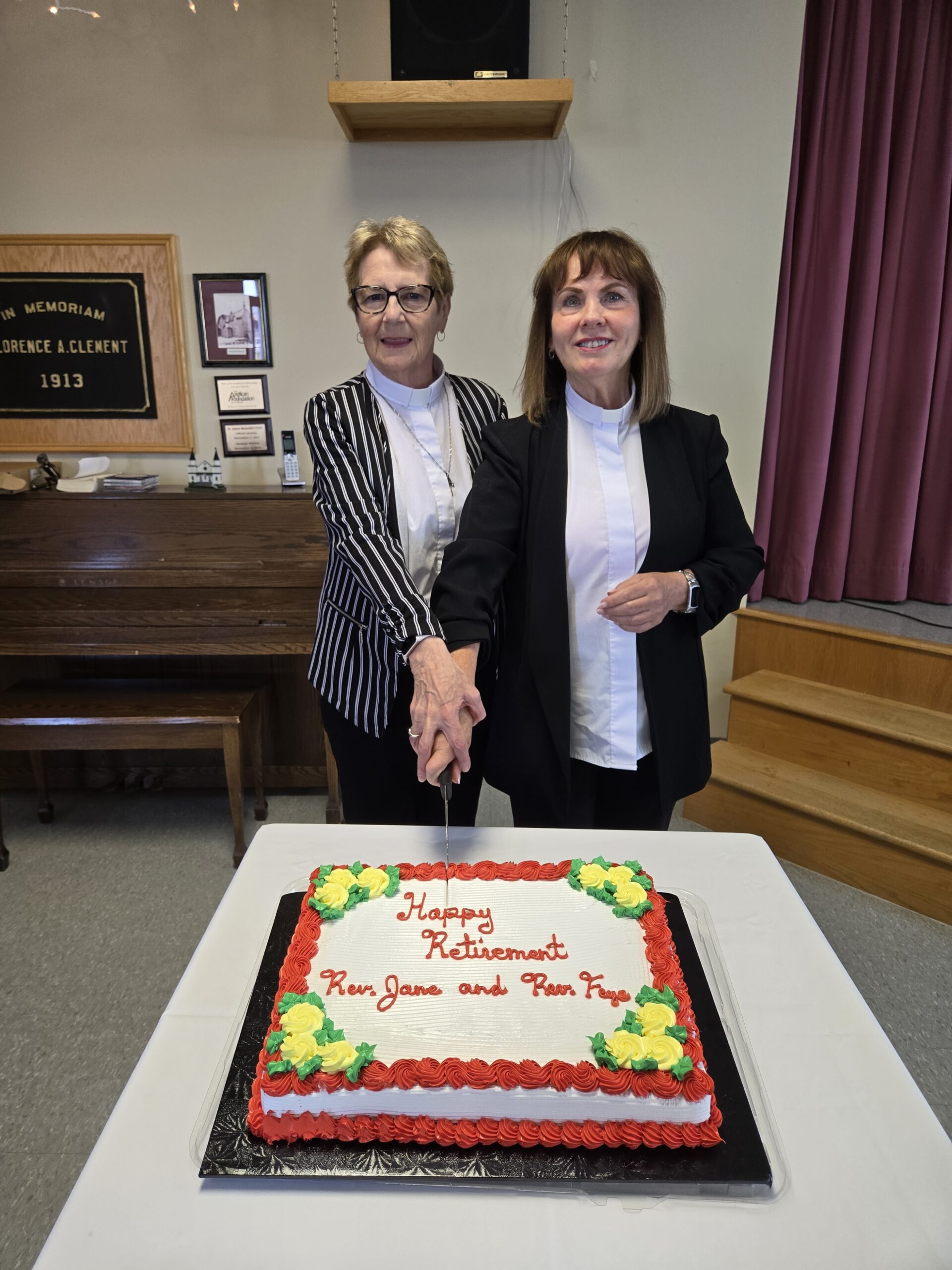 two women cutting a retirement cake