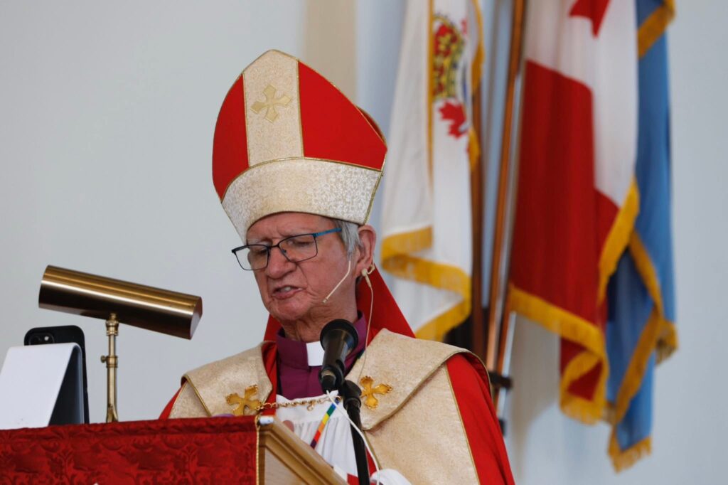 a man dressed in red vestments of an Anglican bishop
