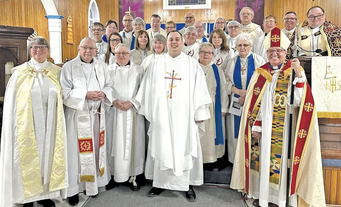 group of clergy at the front of a church immediately after an ordination