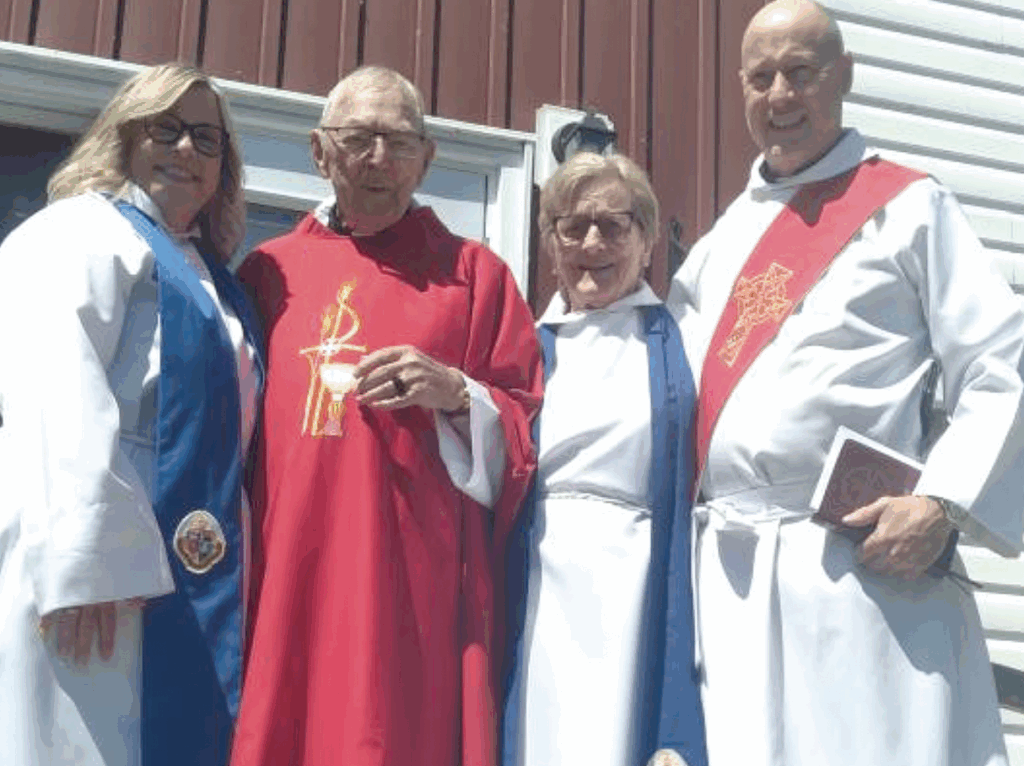 Four people in religious attire standing outdoors.