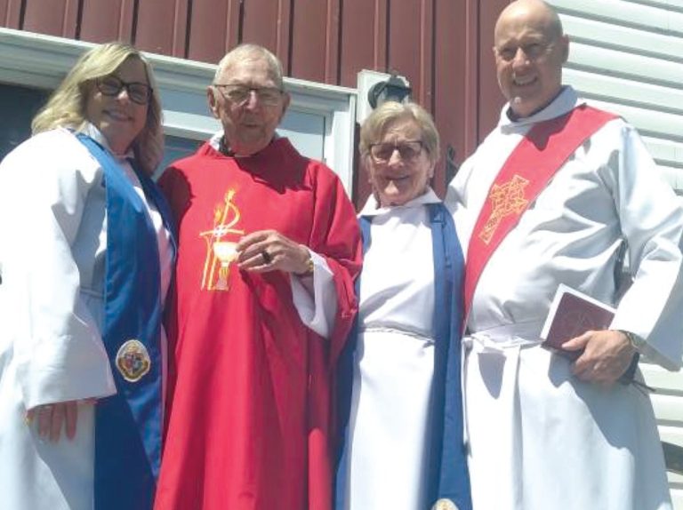 Four people in religious attire standing outdoors.