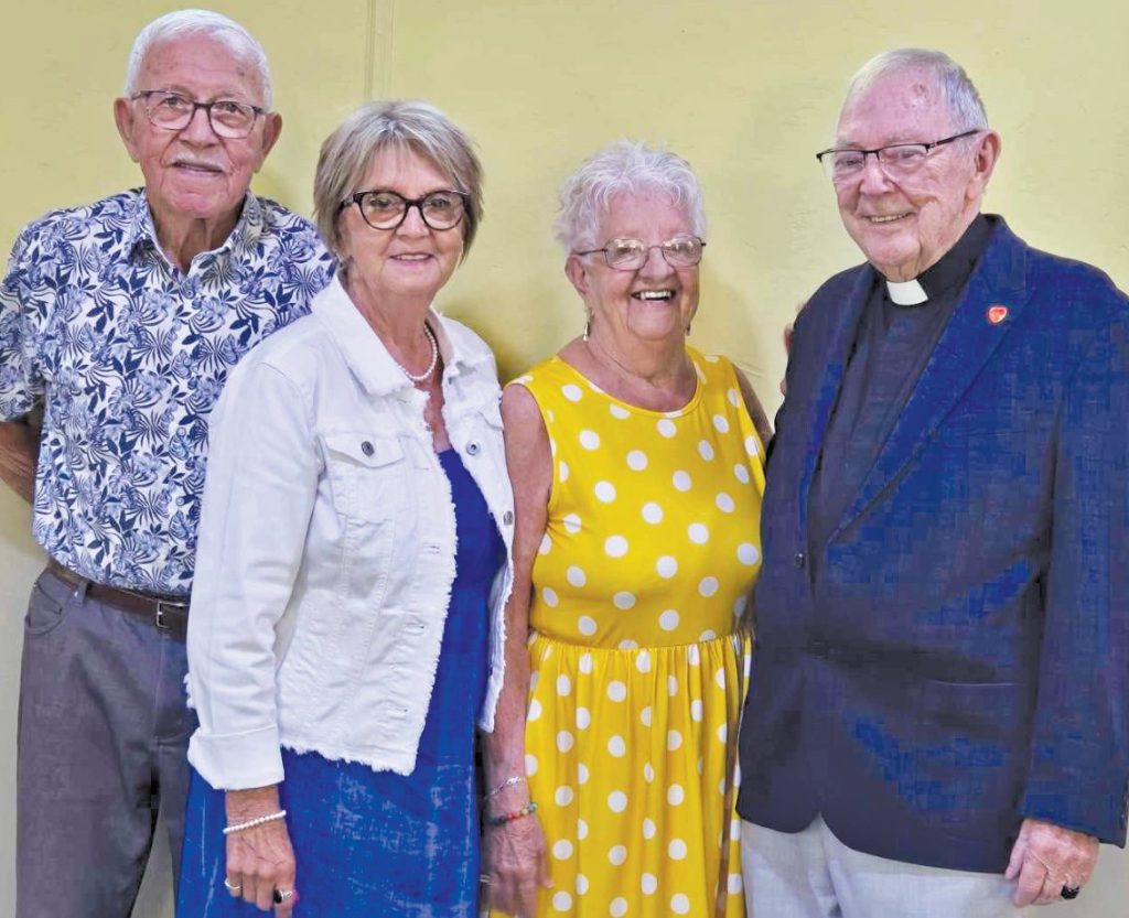 Two men and two women smiling at the camera.