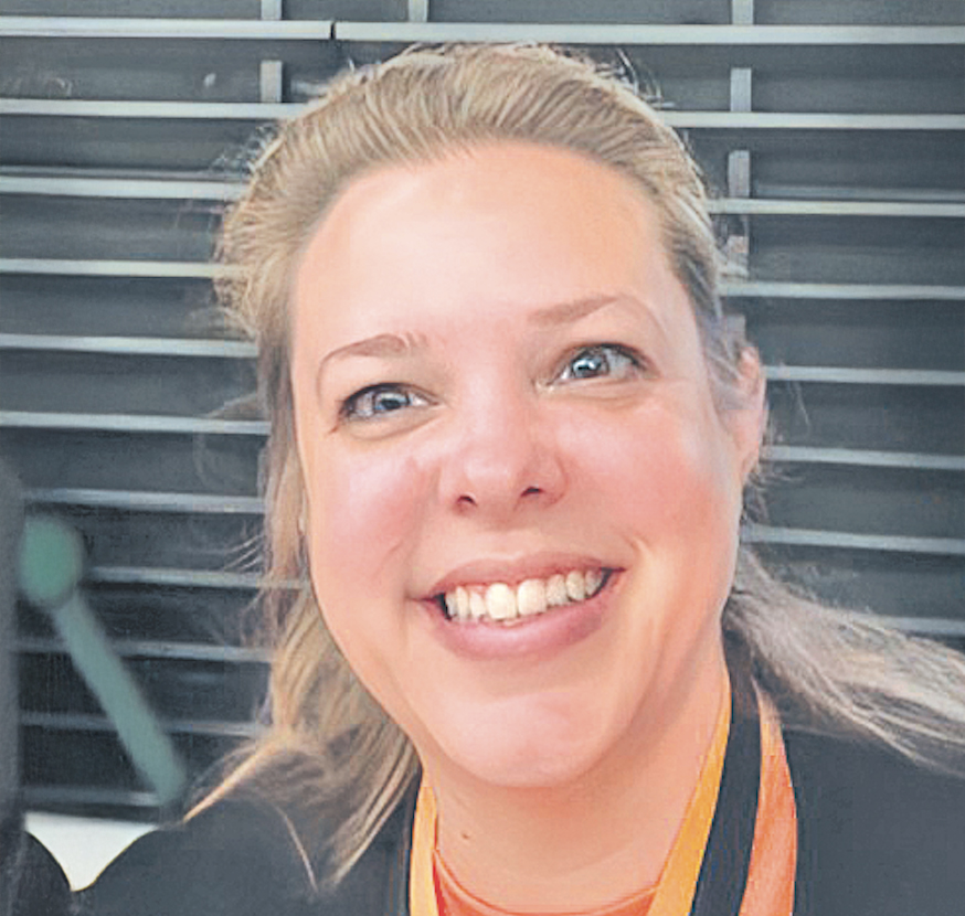 A woman in a black tshirt with a orange lanyard