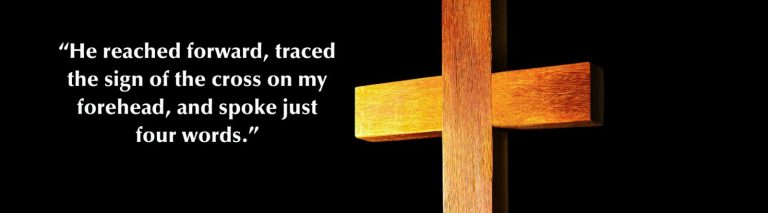 illuminated wooden cross with quotation from this article on the black background